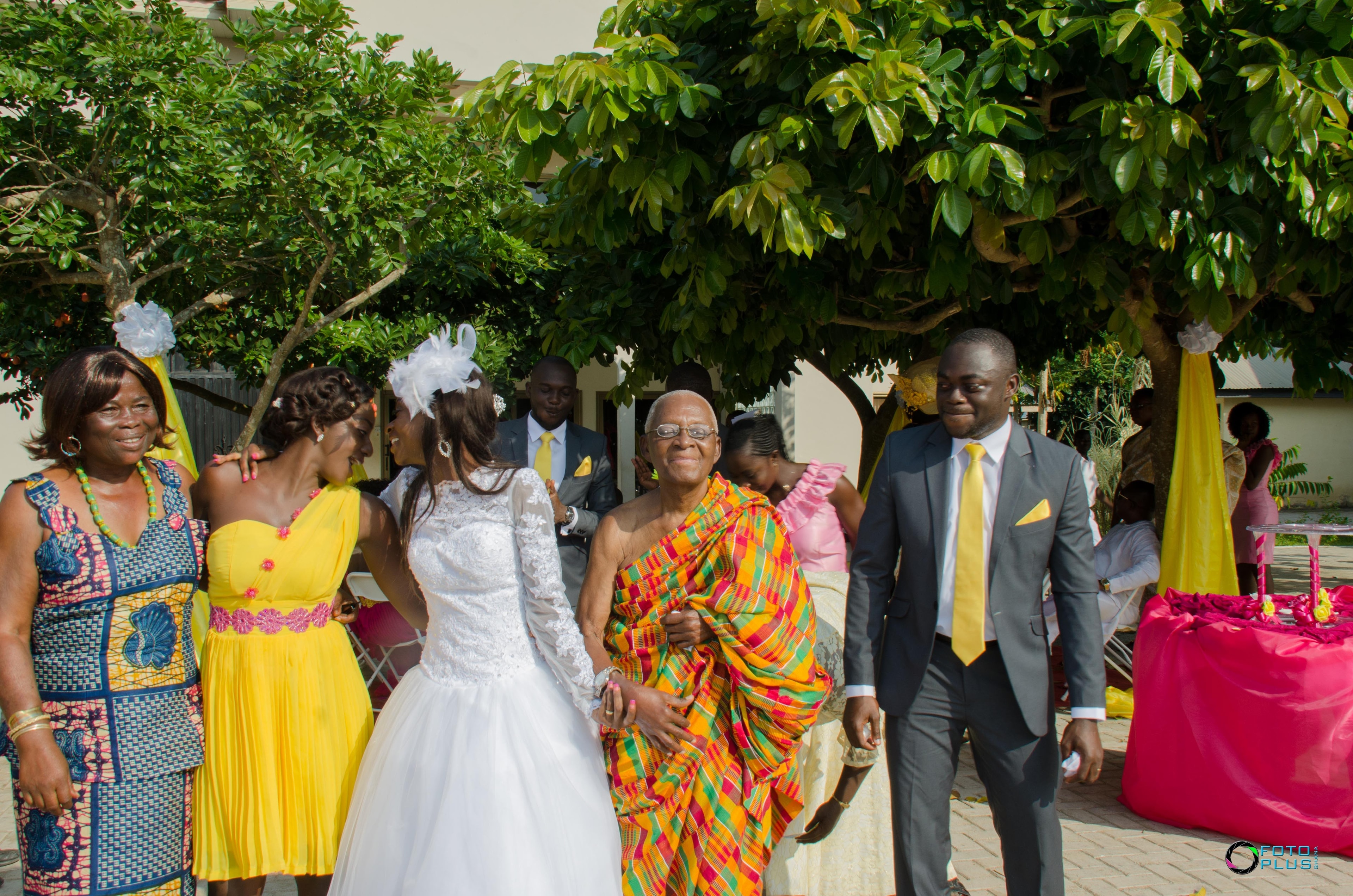 At Pastor Daniel's wedding — draped in vibrant kente, full of joy